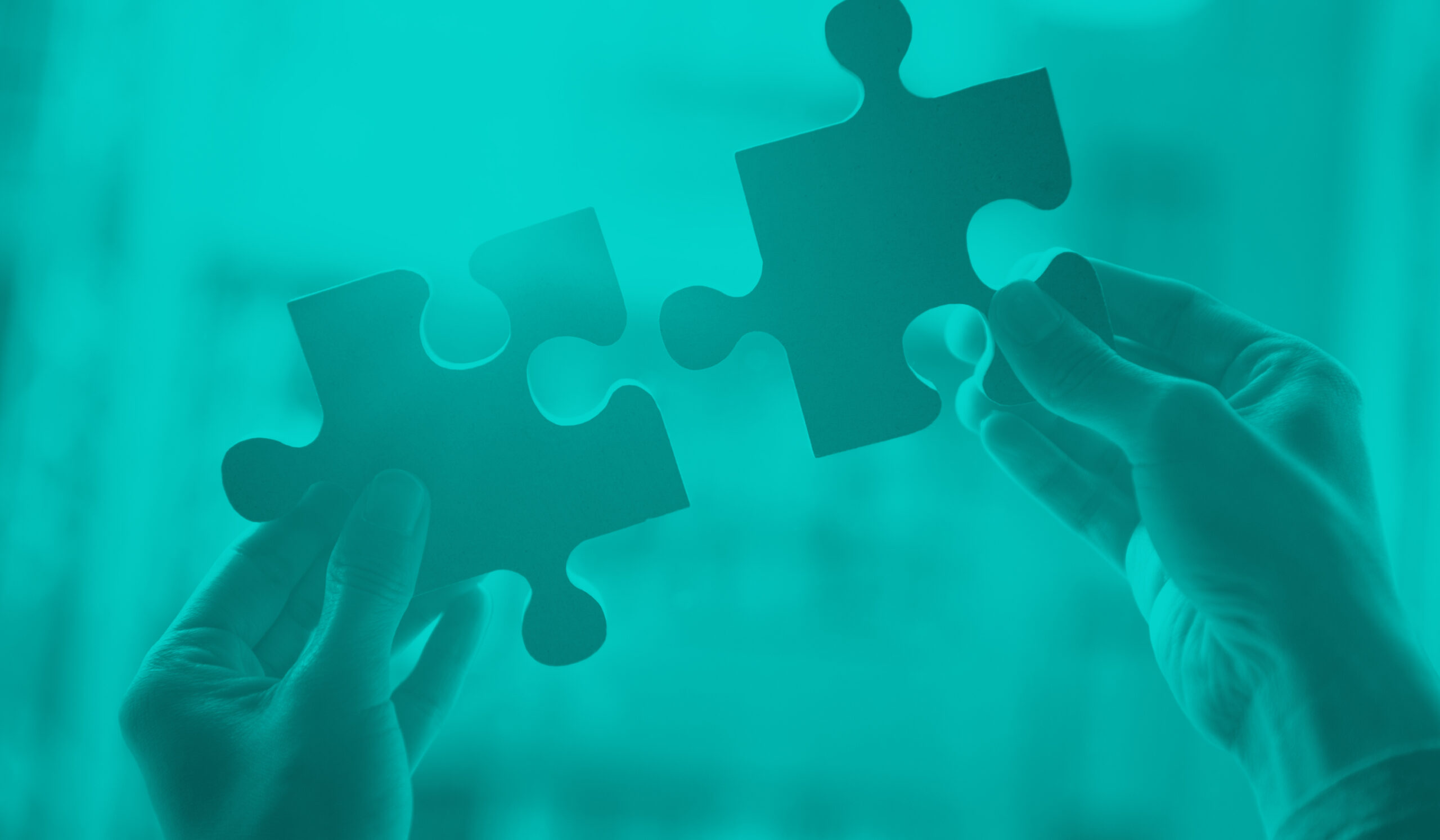 Blog feature photo of human hands holding puzzle pieces that will fit together abstractly representing Omnichannel marketing that integrates together seamlessly