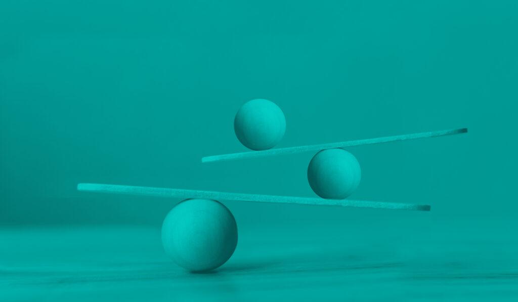 photo of balls balancing on beams on top of each other to illustrate work/life balance