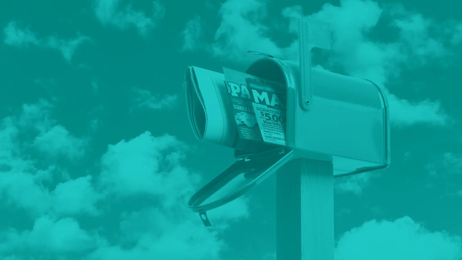 Open mailbox on wooden post with direct mail sticking out of the front. sky with clouds in the background.