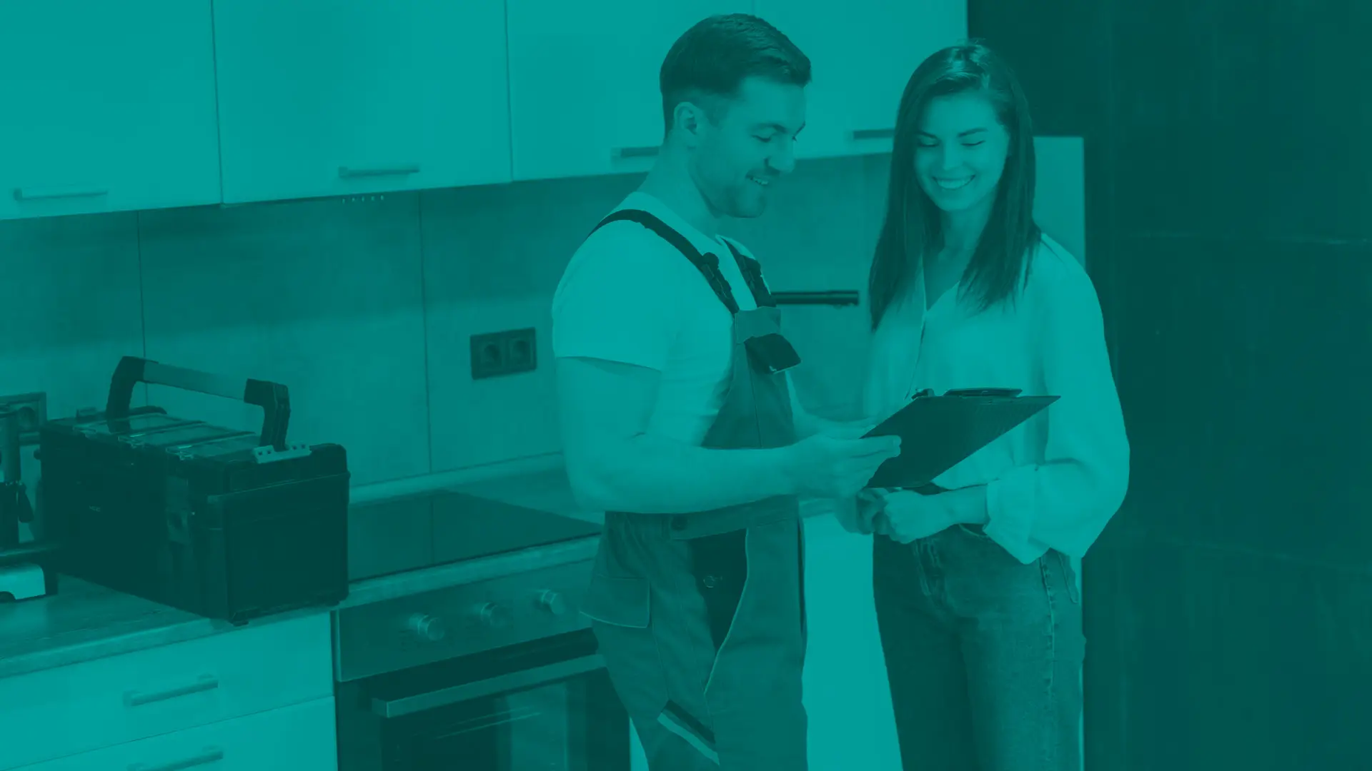 Plunber consulting with homeowner in here kitchen about home services
