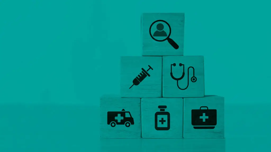 Staclk of wooden blocks showing medical symbols with a block on top showing the symbol of a person to create a medical audience concept.