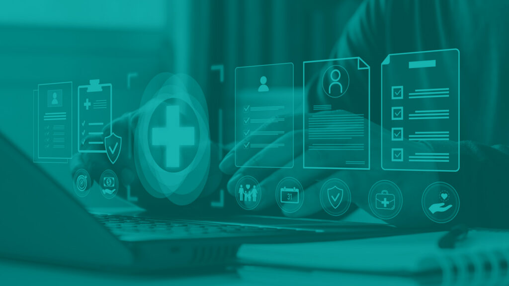 Medical patient records concept. Male hands at a laptop keyboard with floating graphics hanging over showing a medical cross, and symbols for documents, and symbols for patients.